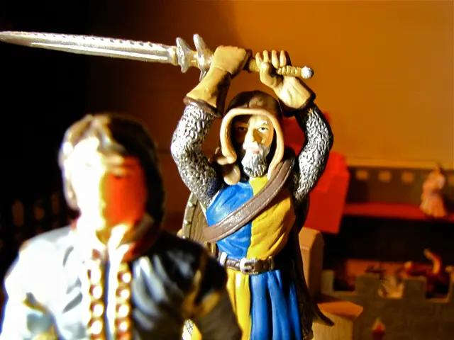 In this image, we can see toys. Background there is a blur view. Here we can see wall, few objects...