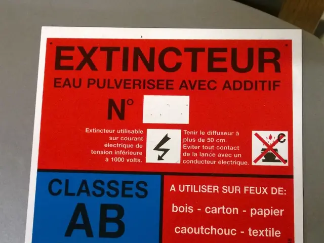 There is a poster which is in red, black and violet color combination pasted on an object. Which is...