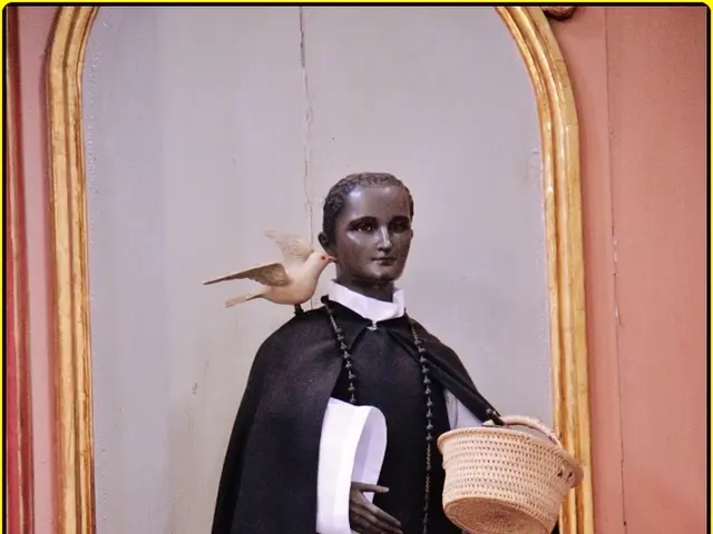 In this picture we can observe a statue of a nun wearing a black and white color dress. There is a...