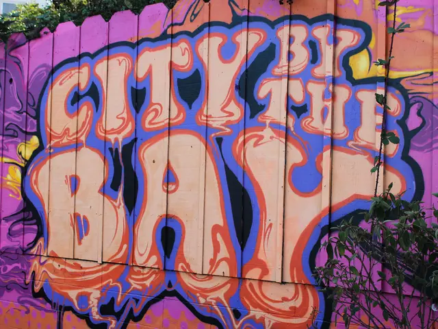 This picture shows graffiti on the wooden wall and we see text and a plant and trees and a...