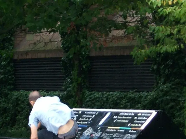 A man and the electronic device is highlighted in this picture. A man is trying to jump from the...