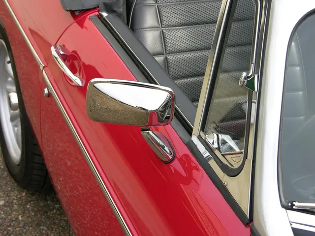 In this image we can see a car which is in red color.