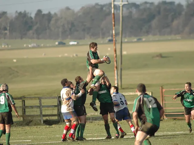 In this image, we can see a group of people are playing a game on the ground. Here a person is...