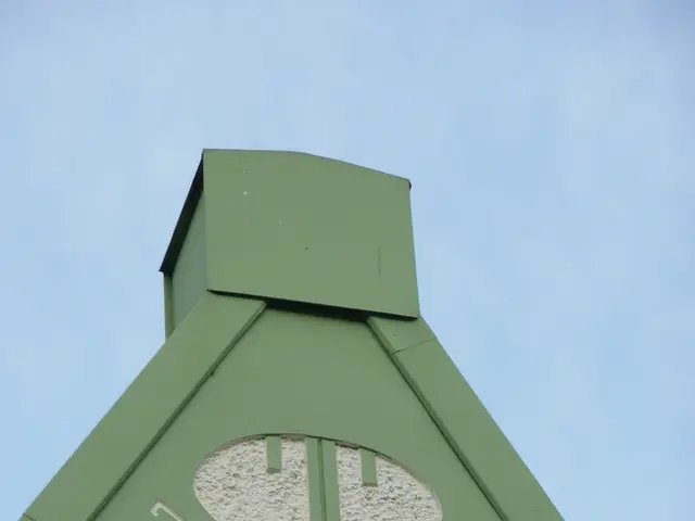 Here we can see wall and glass window. Background we can see sky.