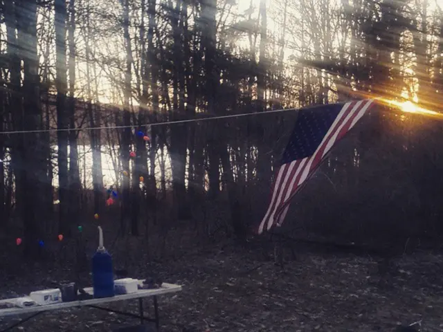 In the image we can see on the table there are utensils kept and on the other table there are wine...